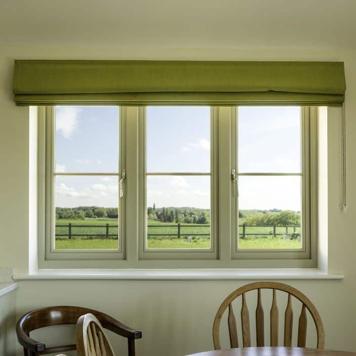 Timber flush casement window in French Grey with 18mm horizontal glazing bars and Newbury polished nickel lever handle.