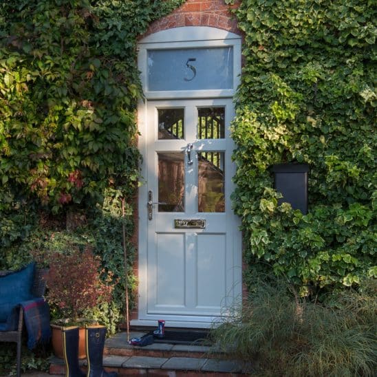 Evolution PVCu Timber Alternative front door with clear glazing and sandblasted top light.
