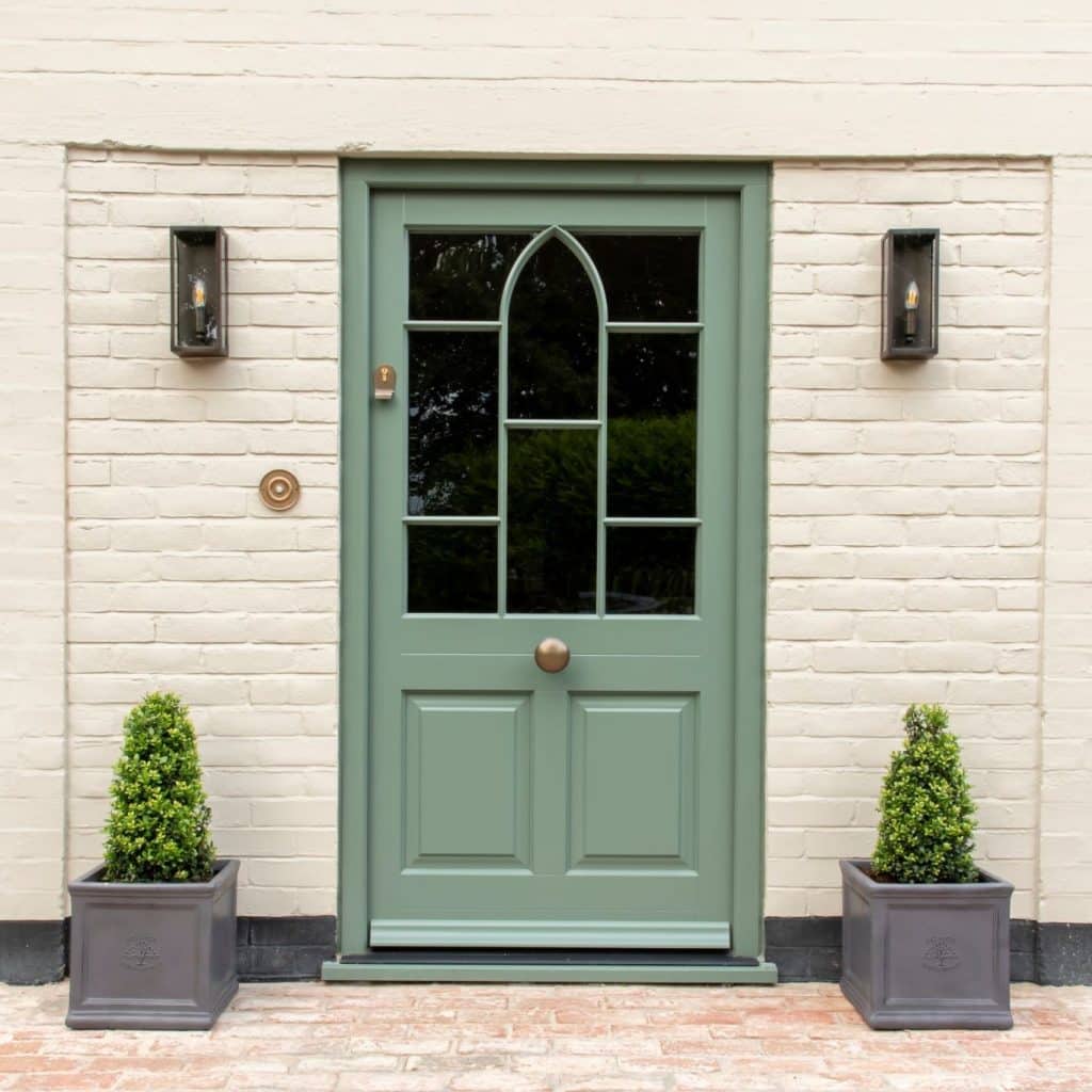 Farrow & Ball Green Smoke Timber Moorbank townhouse door in European redwood with ovolo moulding and a raised and fielded door panel. Flush casement windows in Farrow & Ball Slipper Satin