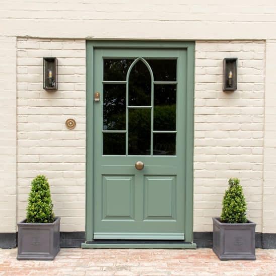 Farrow & Ball Green Smoke Timber Moorbank townhouse door in European redwood with ovolo moulding and a raised and fielded door panel. Flush casement windows in Farrow & Ball Slipper Satin