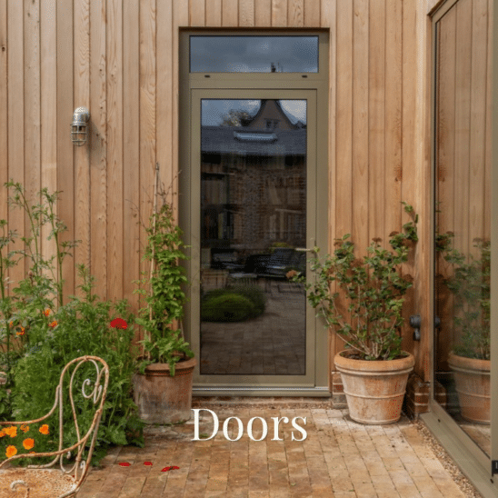 Fully glazed Sunflex aluminium entrance door in Olive Grey with glazed top light and lever handle.