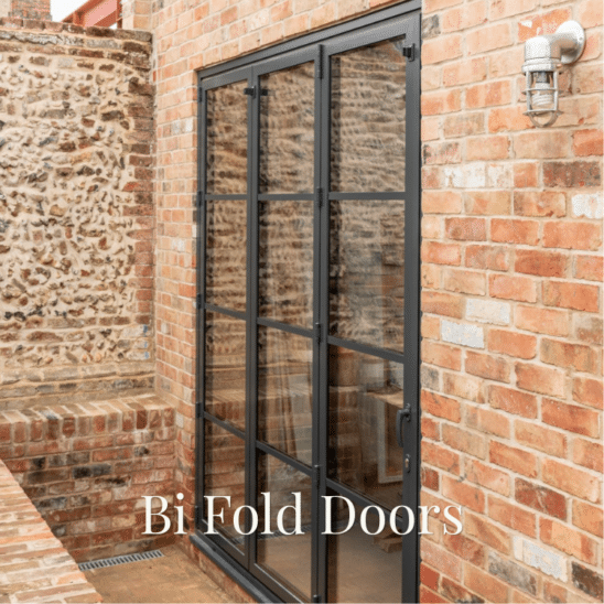Heritage style Sunflex aluminium bi-fold doors with art-deco style glazing bars and in-line handle in anthracite grey.