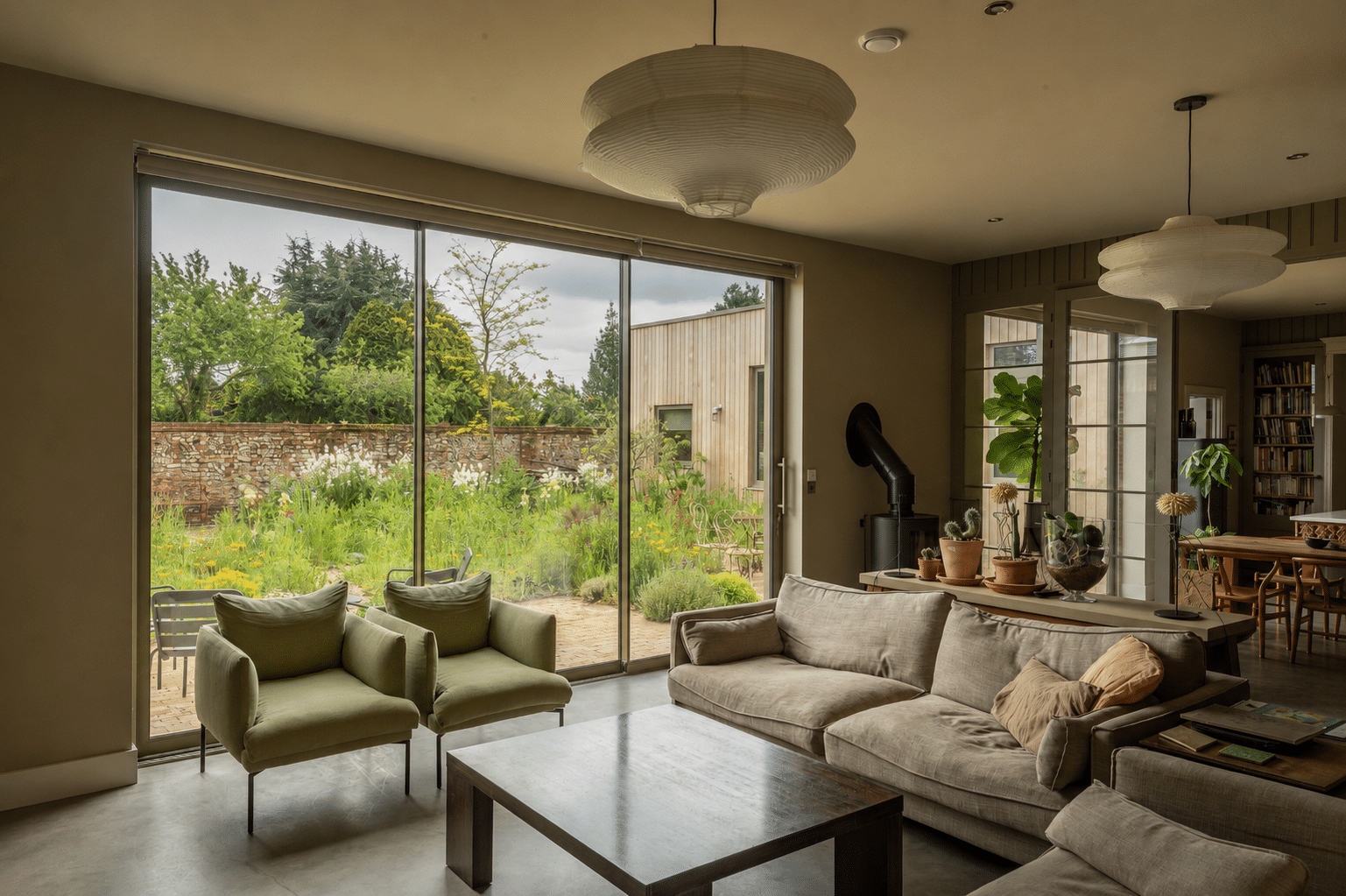 2.8 metre high Sunflex SVG20 aluminium sliding doors in Olive Grey with 20mm sightlines and flush stacking panels. Fitted blinds that operate independently for each panel have been installed by the owners.