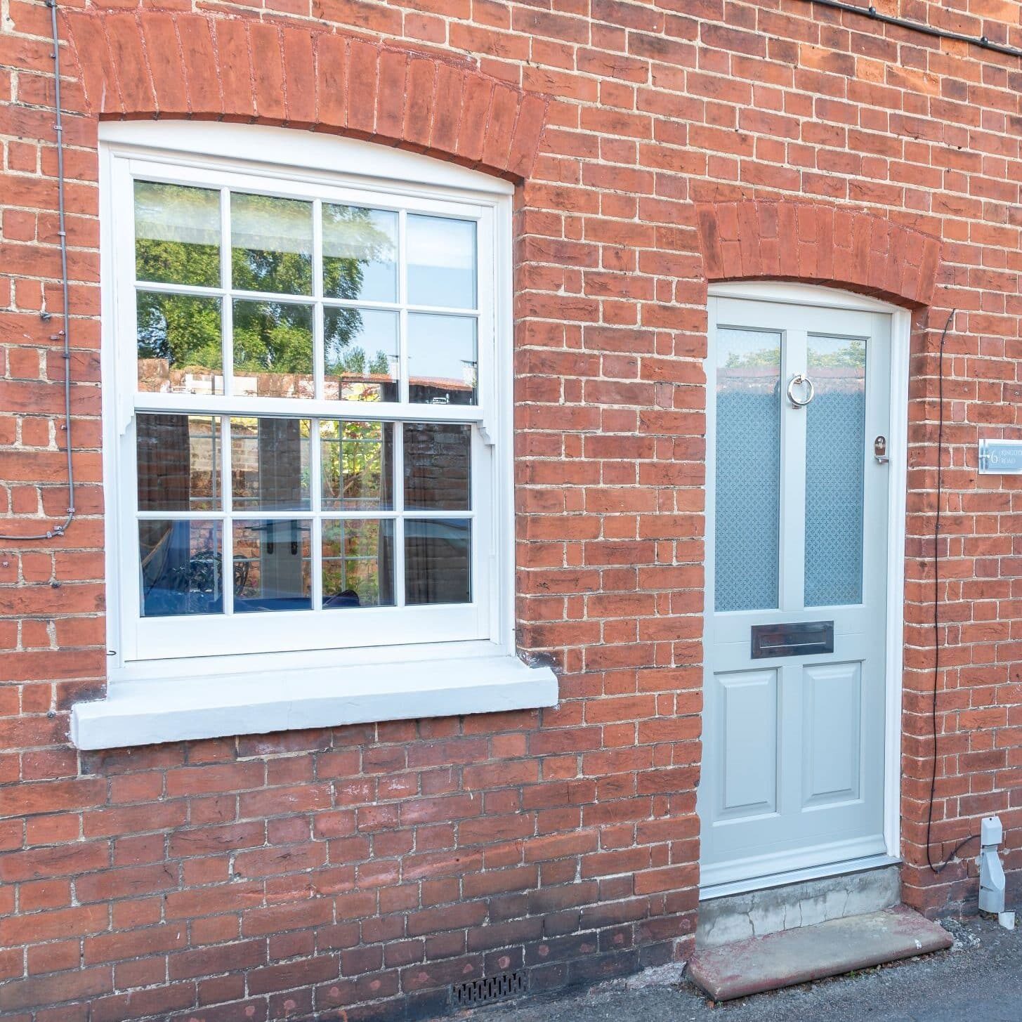 Timber Kingston front door with etched star glass, and Bygone timber alternagove sash window