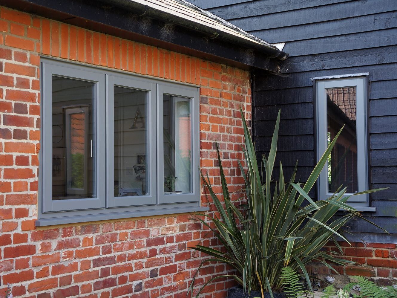 Contemporary Lipped Casement windows (StormProof Windows) in London Grey with stainless steel ironmongery