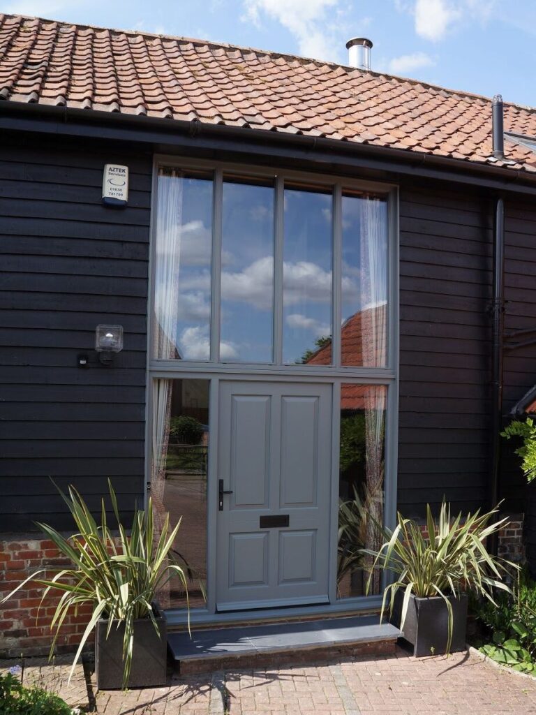 Bevington timber entrance door in London Grey with side and top lights
