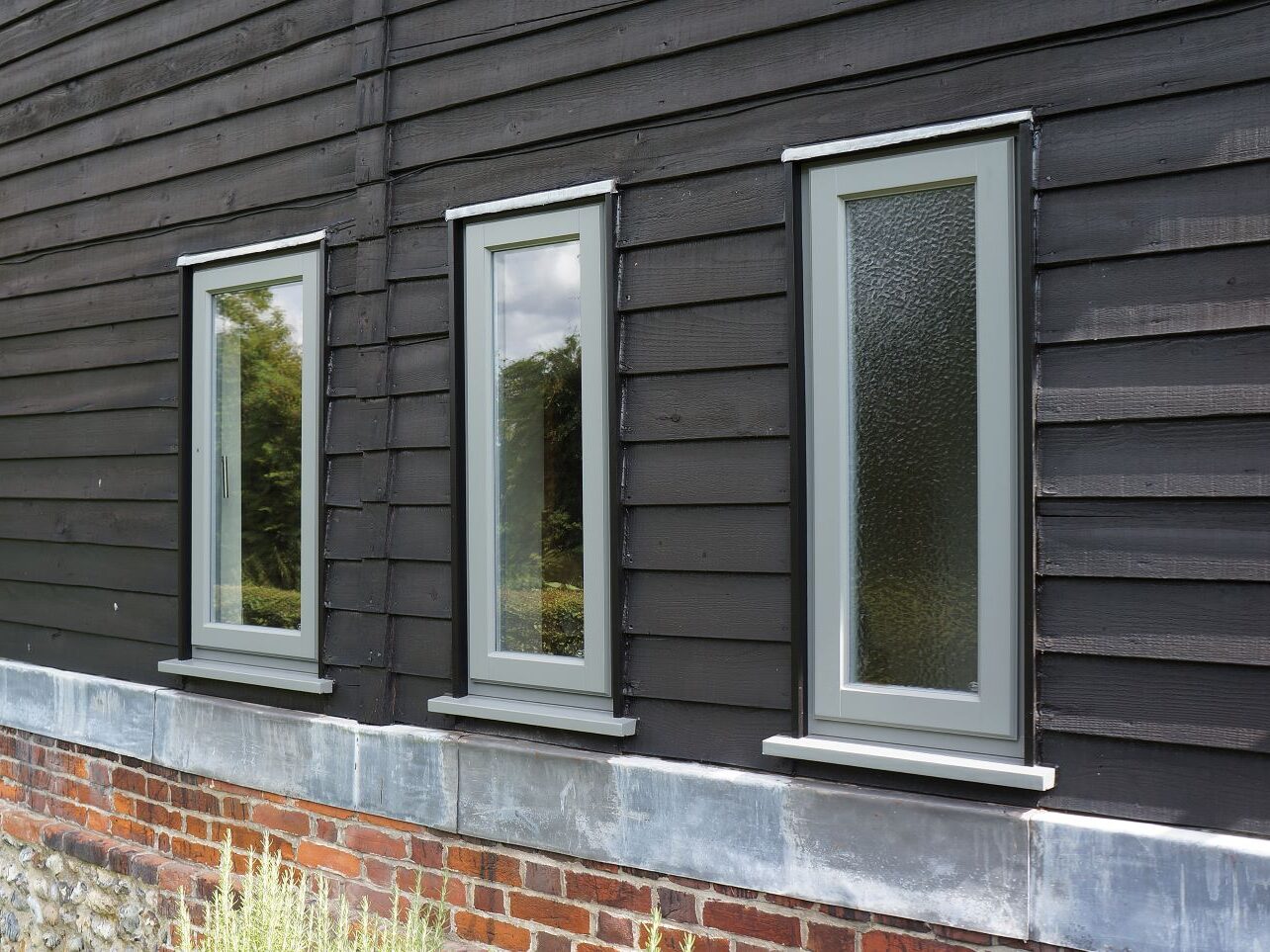 Contemporary Lipped Casement windows (StormProof Windows) in London Grey with stainless steel ironmongery