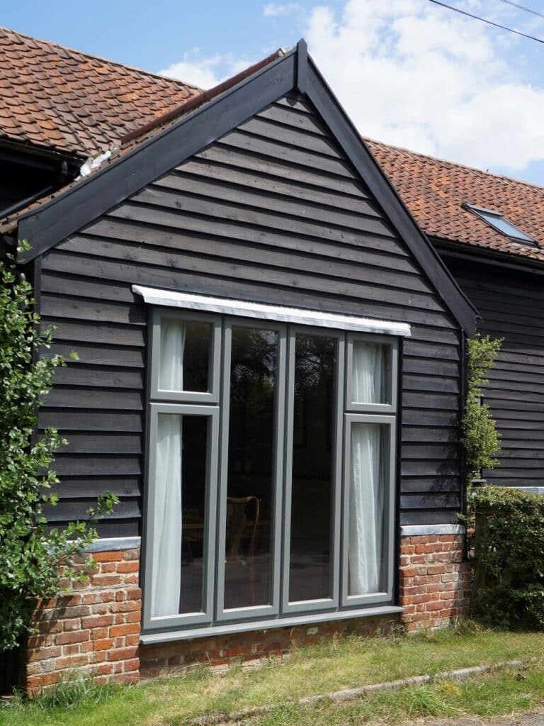 Contemporary Lipped Casement windows (StormProof Windows) in London Grey with stainless steel ironmongery