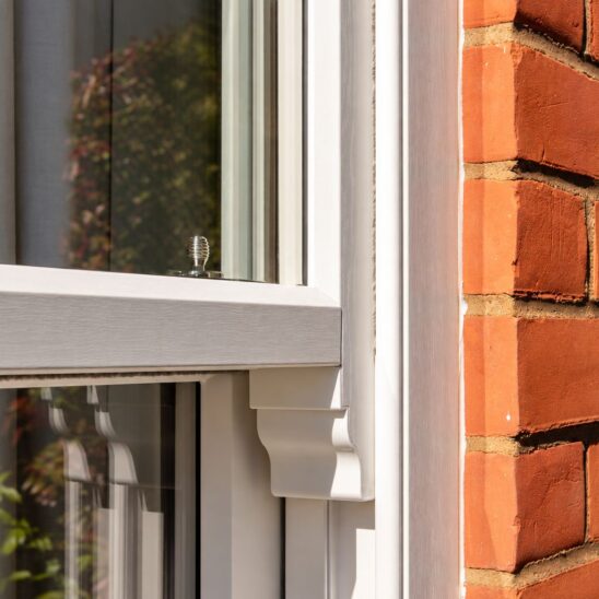 Bygone PVCu sash window with authentic timber look sash horns
