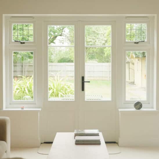 white timber french doors with leaded side windows
