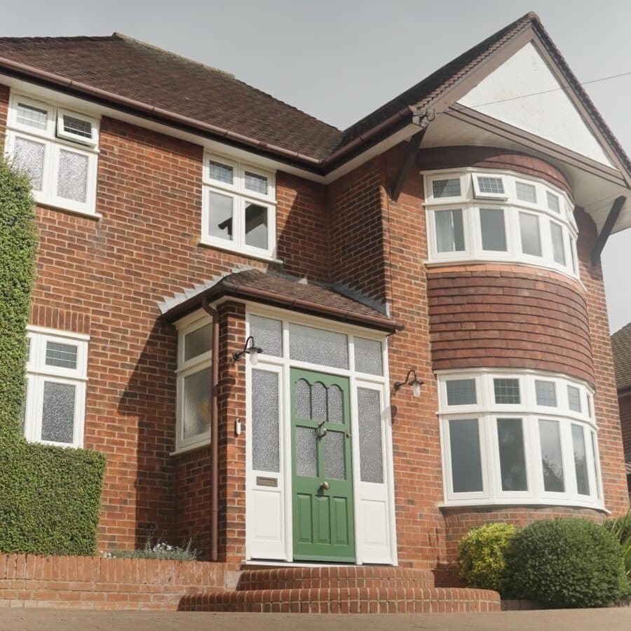 Engineered timber white casement windows with leaded lights & green Polstead timber entrance door