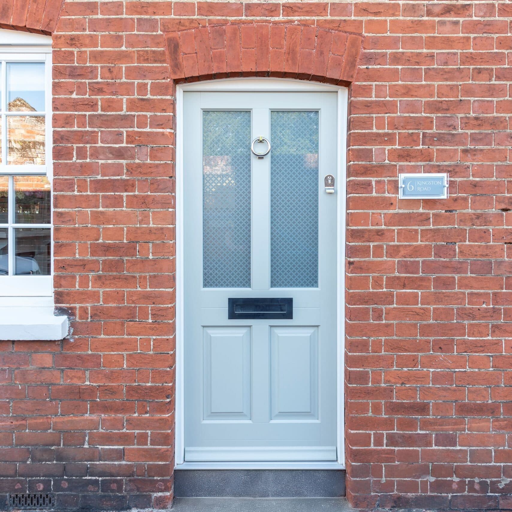 Timber Kingston front door in French Grey with off-white frame, etched star glass and 316 Coastal stainless steel ring knocker. letterbox and handle