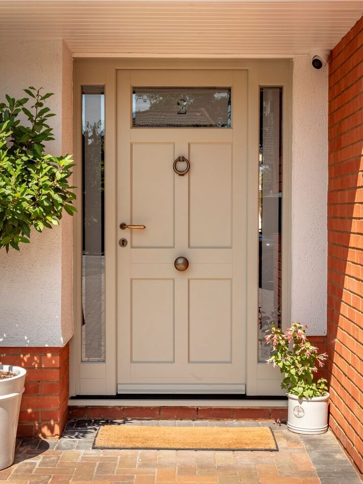 Timber Braithwaite entrance door with side panels in French Grey with bronze Samuel Heath door furniture
