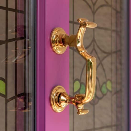 Timber Kingston townhouse door in signal violet with polished brass Coastal 316 Doctor's door knocker & stained glass