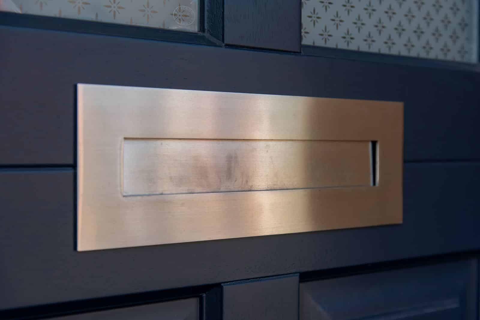 Detail of 316 coastal hardware letterbox in satin stainless steel