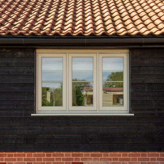 Timber flush casement window in French Grey with 18mm horizontal glazing bars and Newbury polished nickel lever handle.