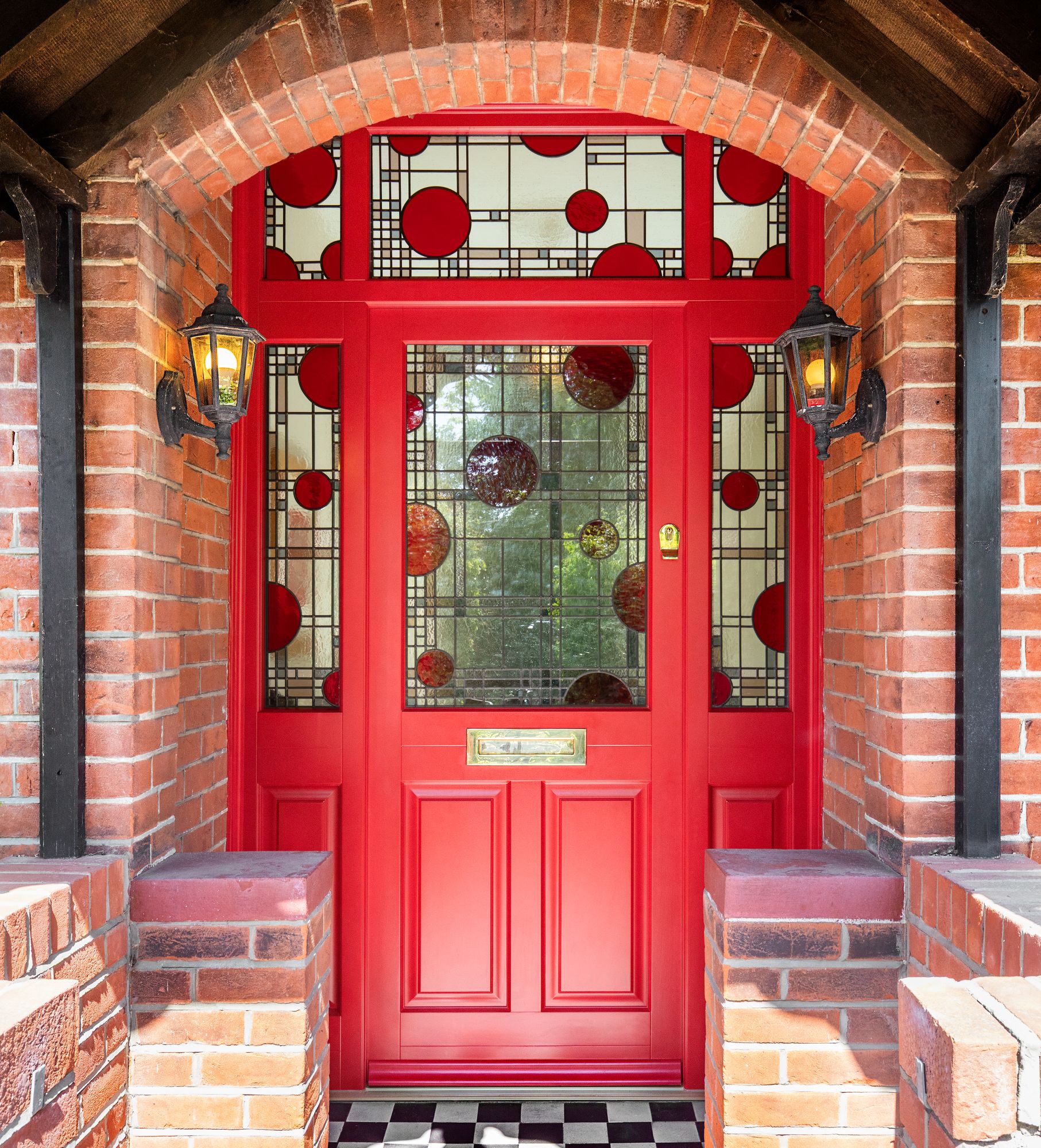 Engineered timber door in red with side and top lights and red circle design stained glass