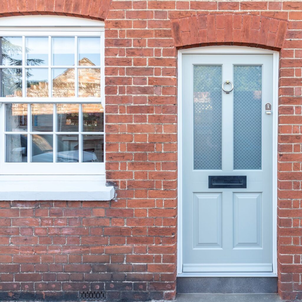Timber Kingston front door in French Grey with off-white frame, etched star glass and 316 Coastal stainless steel ring knocker. letterbox and handle