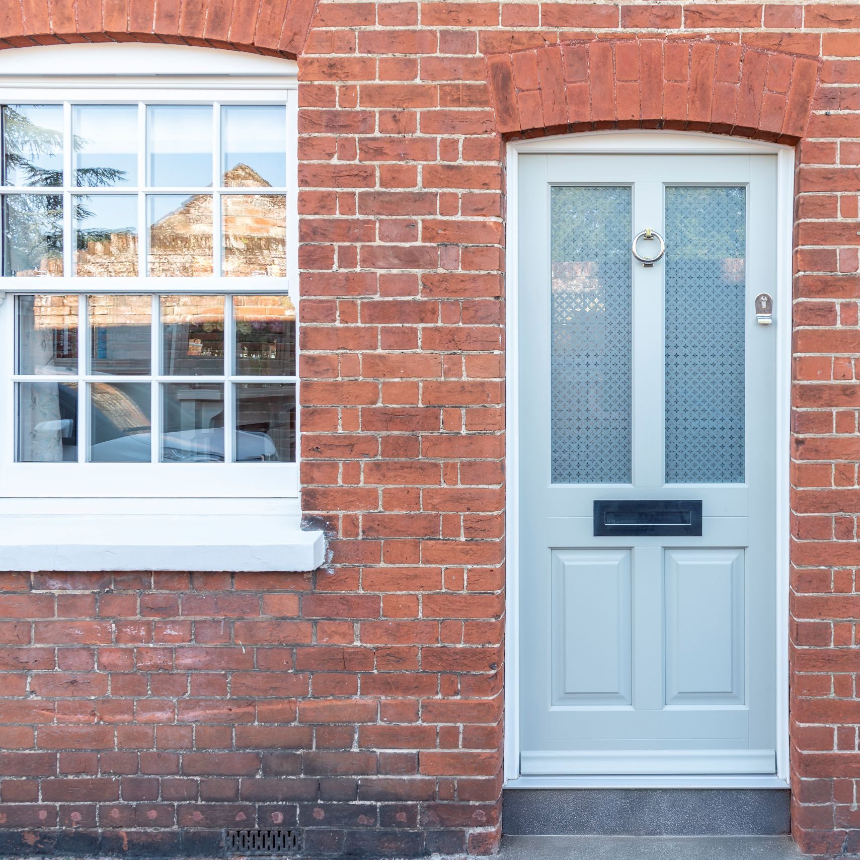 Timber Kingston front door in French Grey with off-white frame, etched star glass and 316 Coastal stainless steel ring knocker. letterbox and handle