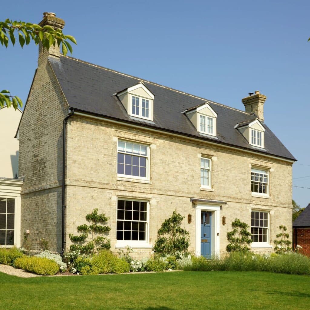 Slim timber sash windows in Farrow & Ball Slipper Satin and Chalfont timber entrance door in Farrow & Ball Stiffkey Blue
